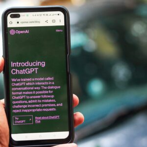 Webpage of ChatGPT, a prototype AI chatbot, is seen on the website of OpenAI, on a smartphone. Examples, capabilities, and limitations are shown.